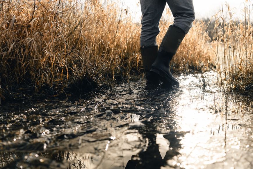 person walking in wellies through puddle